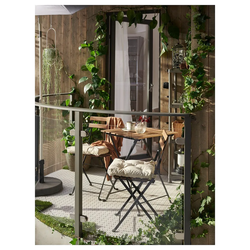 TÄRNÖ Table+2 chairs, outdoor, black/light brown stained foldable/foldable Kuddarna light grey-beige, 55x54 cm