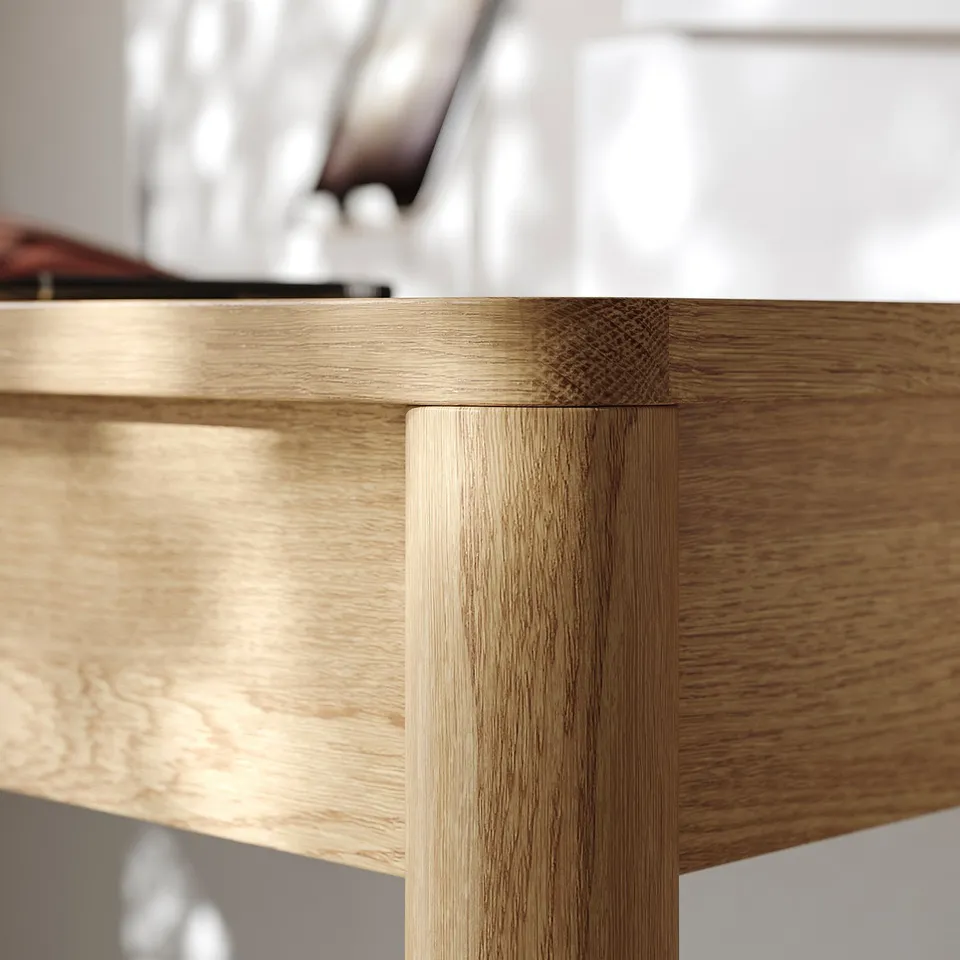 Close-up of TONSTAD desks oak veneer joint, showcasing quality craftsmanship