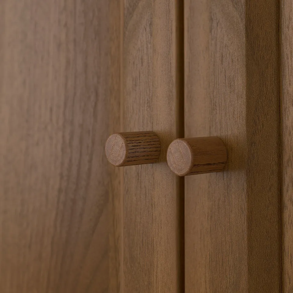 Walnut-brown wooden drawer with two round, knurled knobs. Finished with smooth, tactile texture.