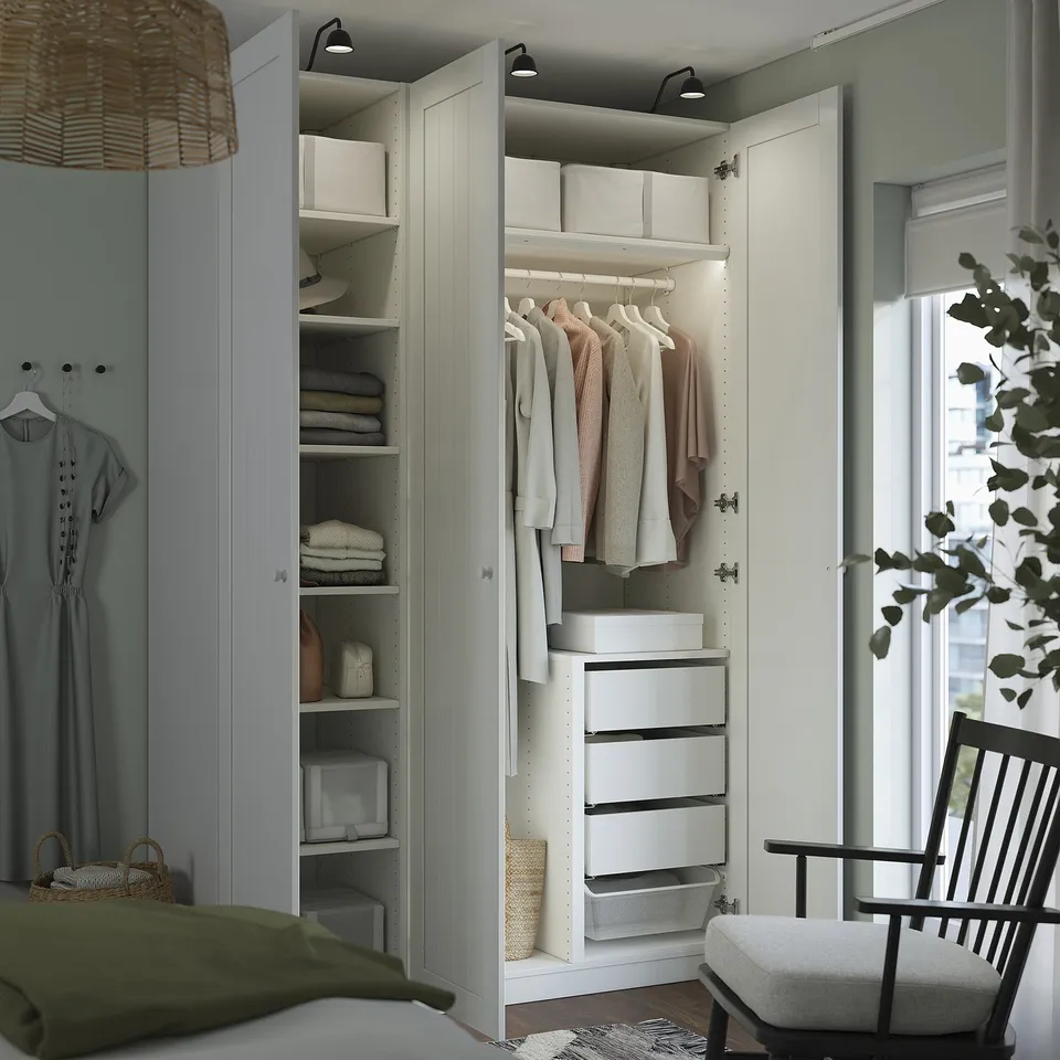 Closed wardrobe with shelves and drawers, neatly organised clothes and storage boxes.