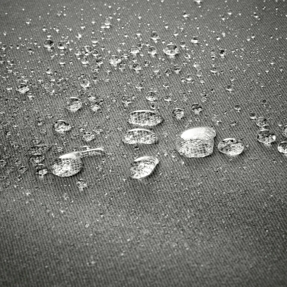 Water droplets bead on textured fabric, demonstrating water resistance.