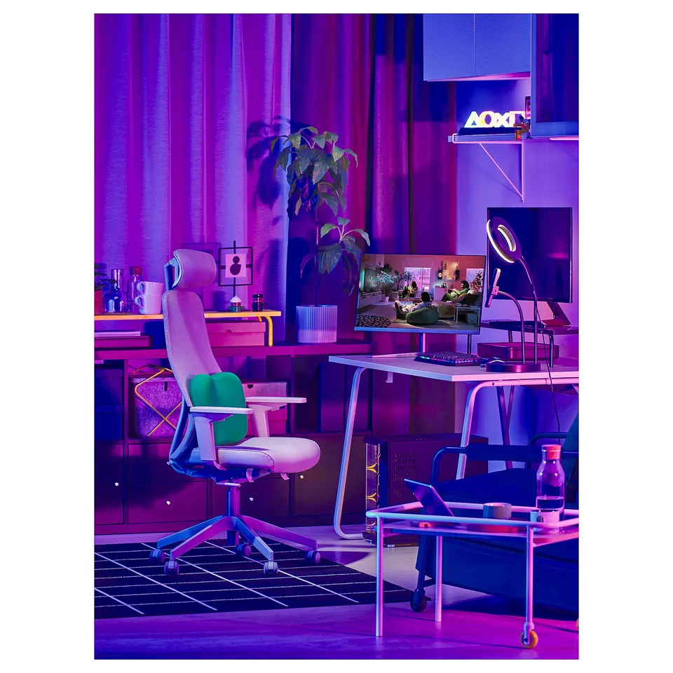 Modern gaming setup with LÅNESPELARE monitor stand, featuring dual screens, ergonomic chair, neon lights, and vibrant decor.