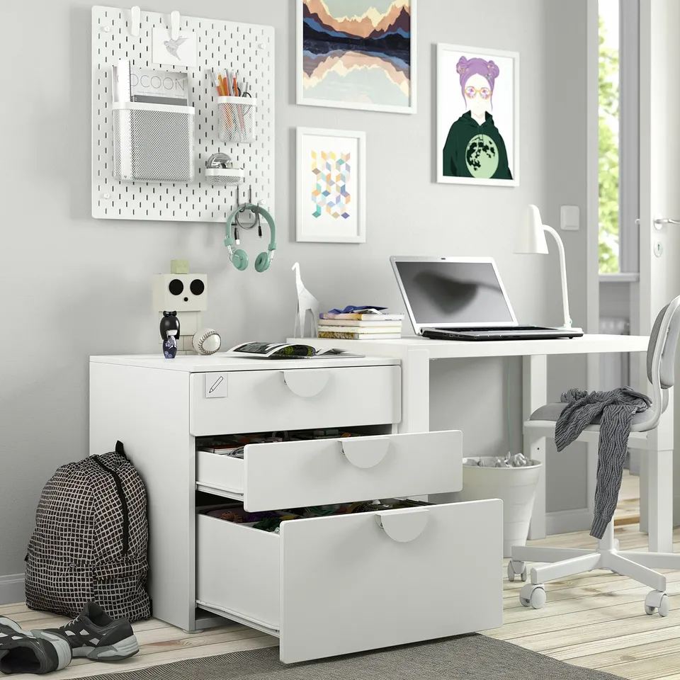 Low white chest of drawers with open top for small items, perfect for kids to reach and organise their belongings.