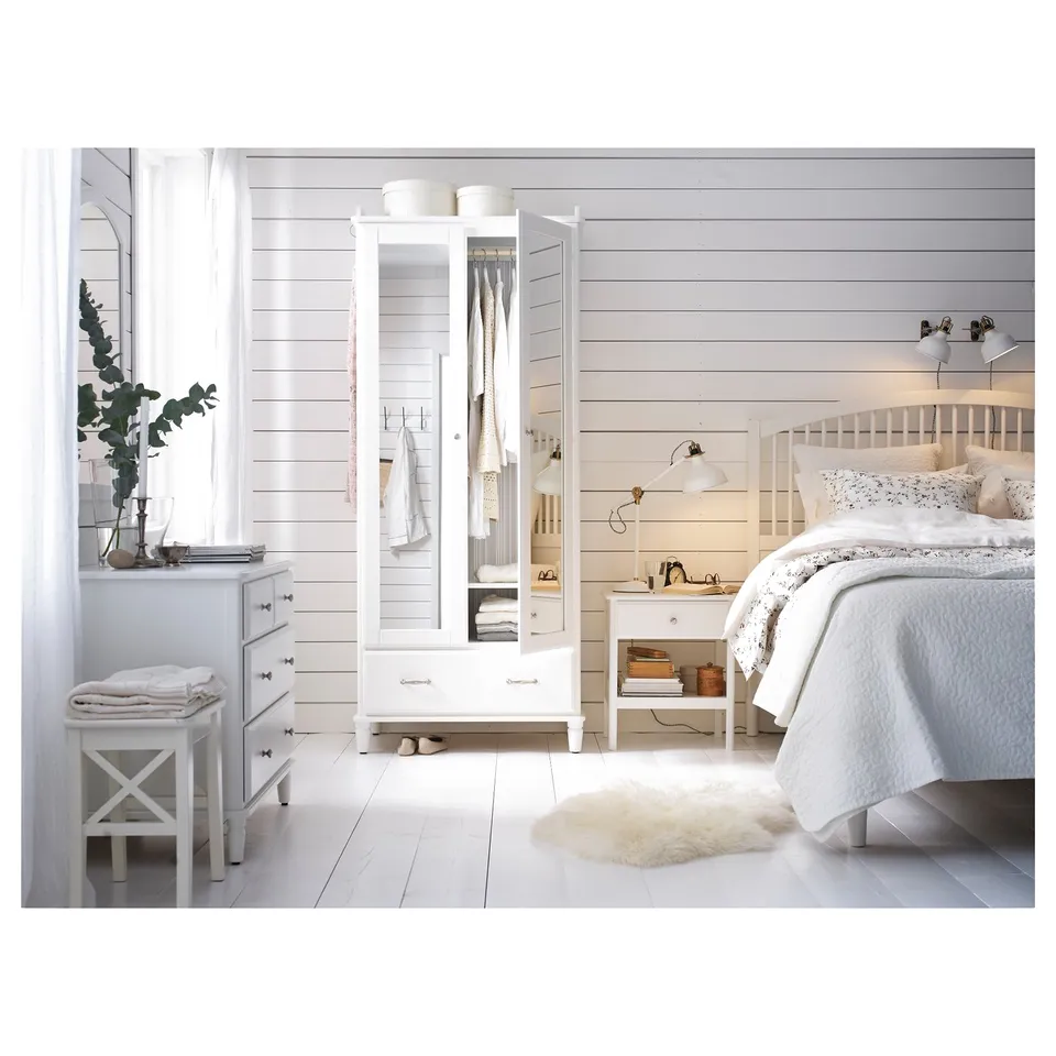 Bright, white scandinavian-style bedroom with TYSSEDAL bed frame, sleek wardrobe, white-washed floors, and minimalist decor.