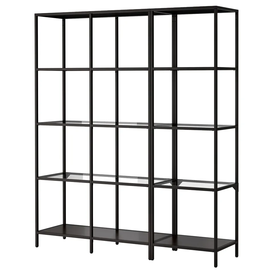 A VITTSJÖ bookshelf in black. This modern shelf has tempered glass panels, a metal frame, and adjustable feet for stability on uneven floors.
