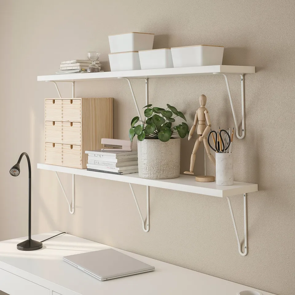 Modern wall shelves with brackets provide space-saving vertical storage. Displayed with decorative items, plants, and office supplies.