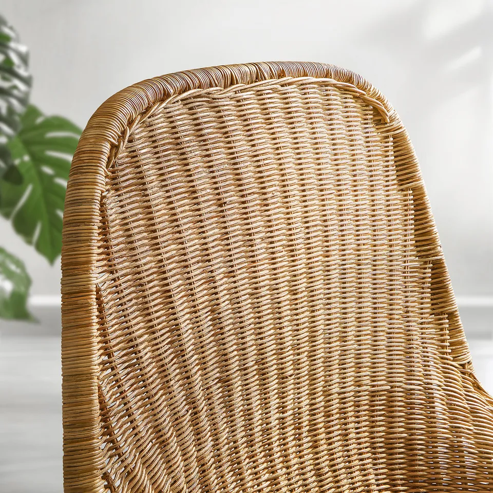 Wicker chair with intricate weave and curved backrest, showcasing high-quality craftsmanship.
