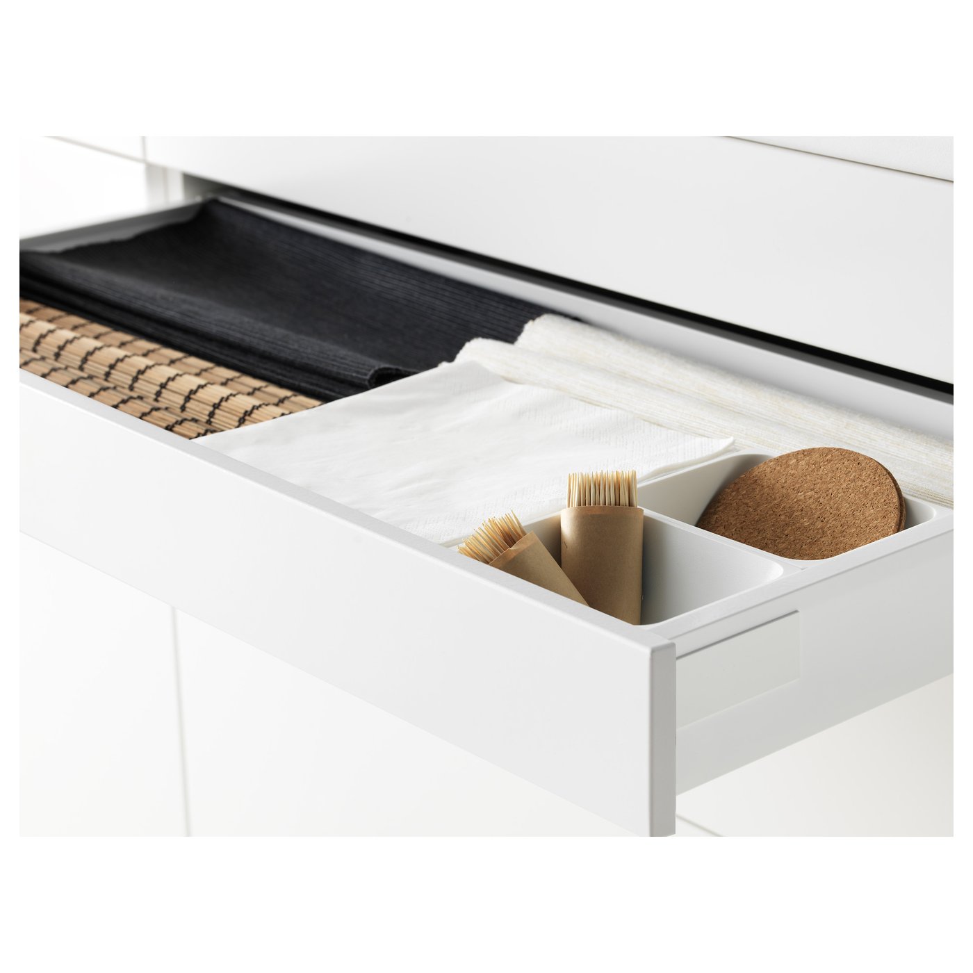 Organised drawer with divider, brushes, cloth, and coaster in modern kitchen.