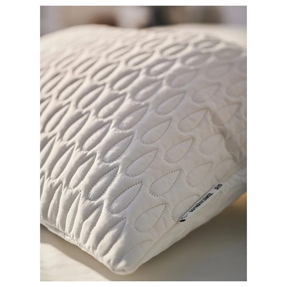 White pillow protector with soft, textured wadding and discreet waterproof layer.