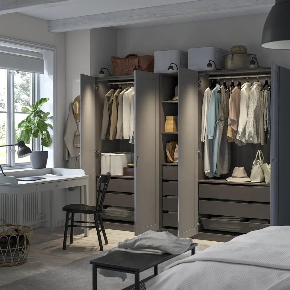 Modern bedroom with PAX wardrobe, hangers, shelves, drawers, and integrated lights.