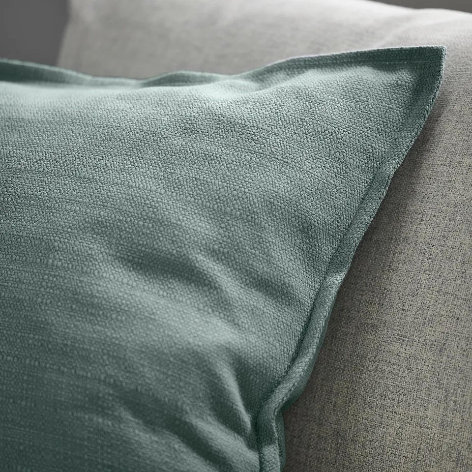 Gray-blue cushion on couch.