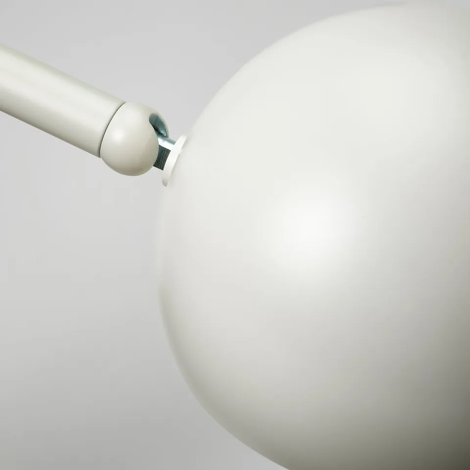 Modern white lamp with adjustable arm, illustrating minimalist design quality.