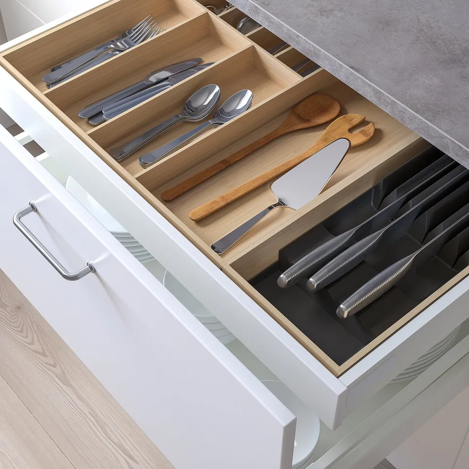 Organised kitchen drawer with cutlery and utensils.