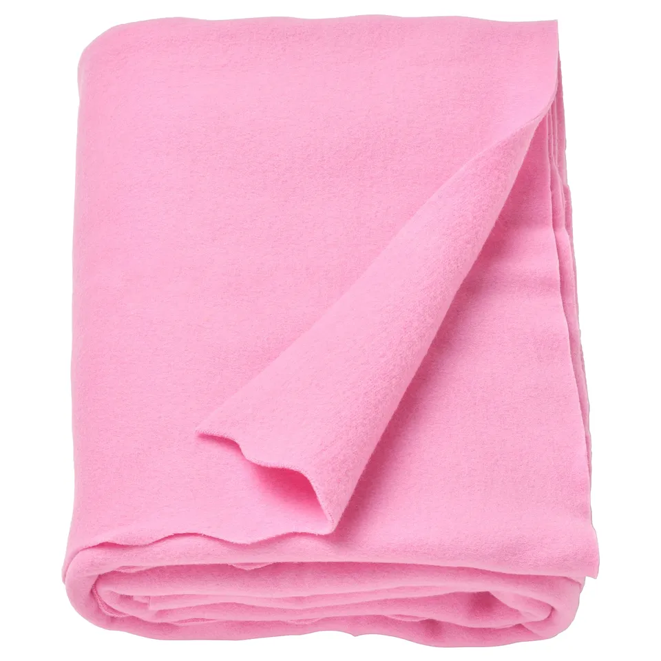 A pink recycled polyester fleece throw blanket folded neatly.