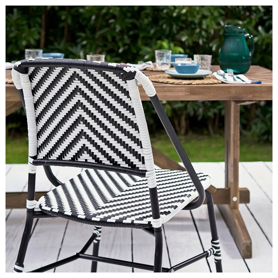 Modern monochrome VASSHOLMEN patio chair, woven, black-white, comfortable for dining.