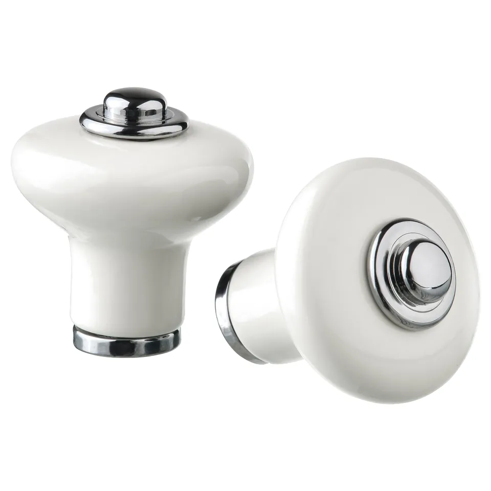 Two white KLINGSTORP knobs with a porcelain-like finish, chrome accents, and a rounded design.