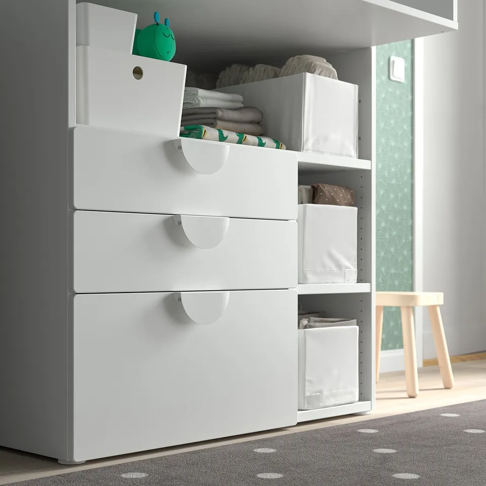 Modern white dresser with multiple drawers and storage boxes. Perfect for kids rooms, organising clothes and toys.