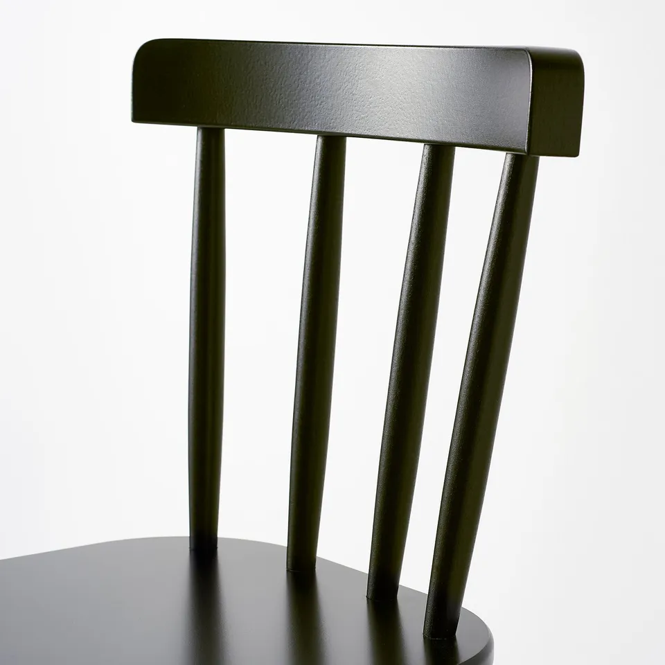 Dark green junior chair close-up with sleek, modern design and sturdy wooden legs.