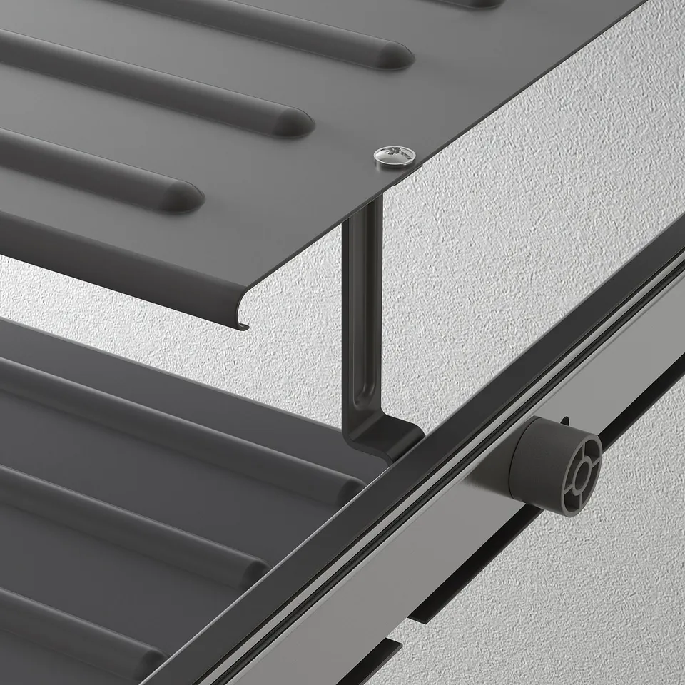 Close-up of a sturdy metal shoe shelf with alternating levels for organised storage, mounted on a wall with robust brackets.