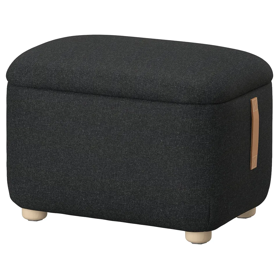 Oskarshhamn footstool: dark grey, fabric-covered, square shape with curved edges, wooden legs, and leather handle.