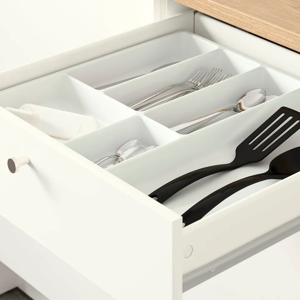 Kitchen drawer organiser with cutlery and utensils.