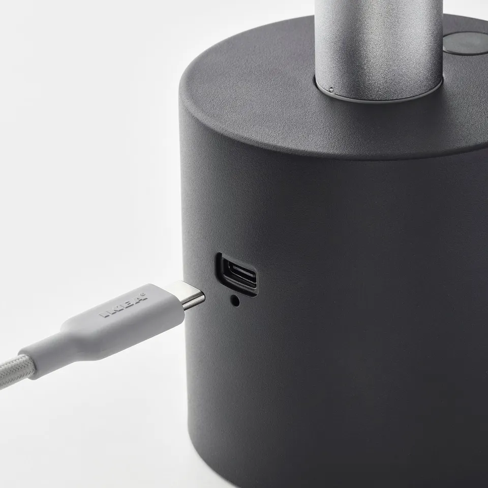 Black portable lamp with usb-c charging port and connected cable.