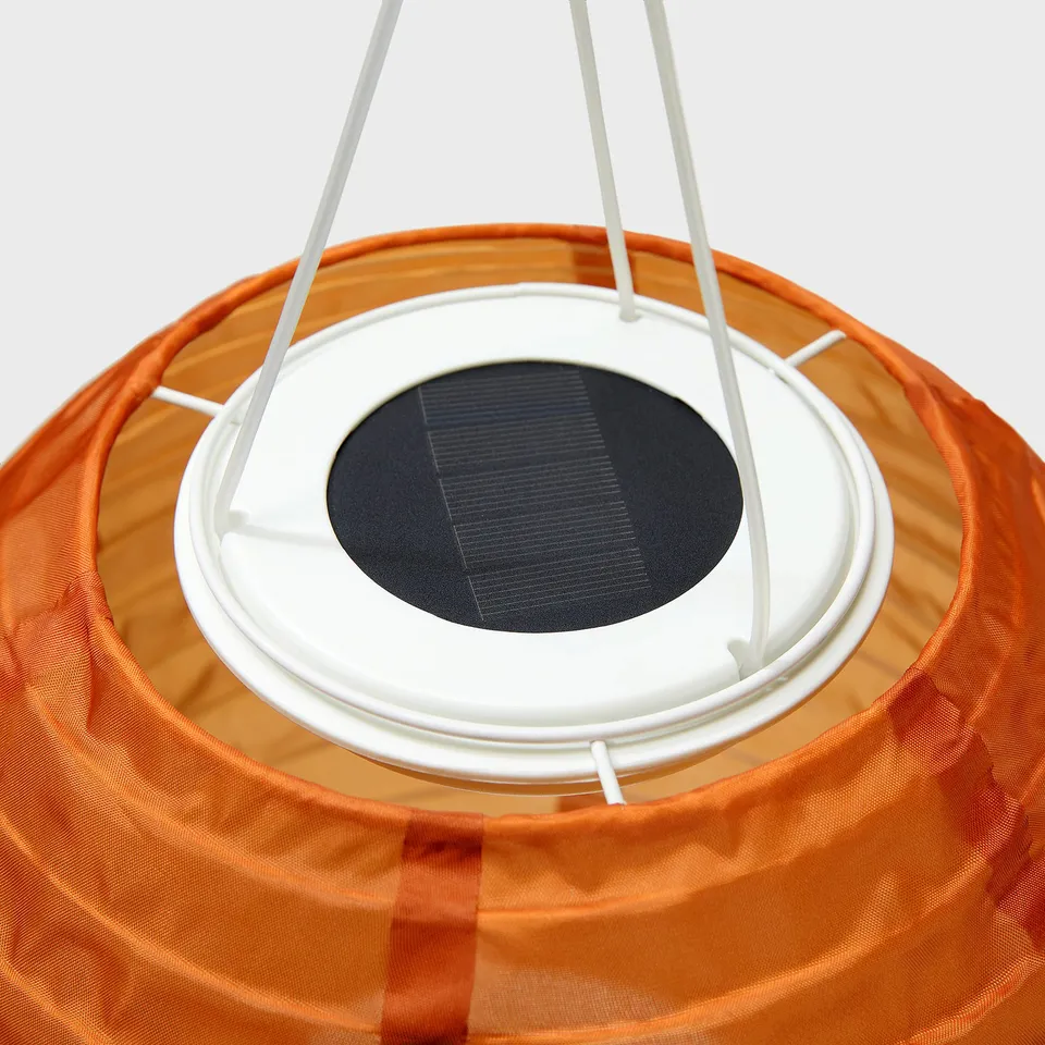 Solar-powered orange outdoor pendant lamp with white top, showcasing quality design and eco-friendly materials.