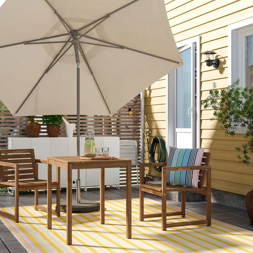 NÄMMARÖ outdoor furniture set with table, chairs, rug, umbrella, and decor.