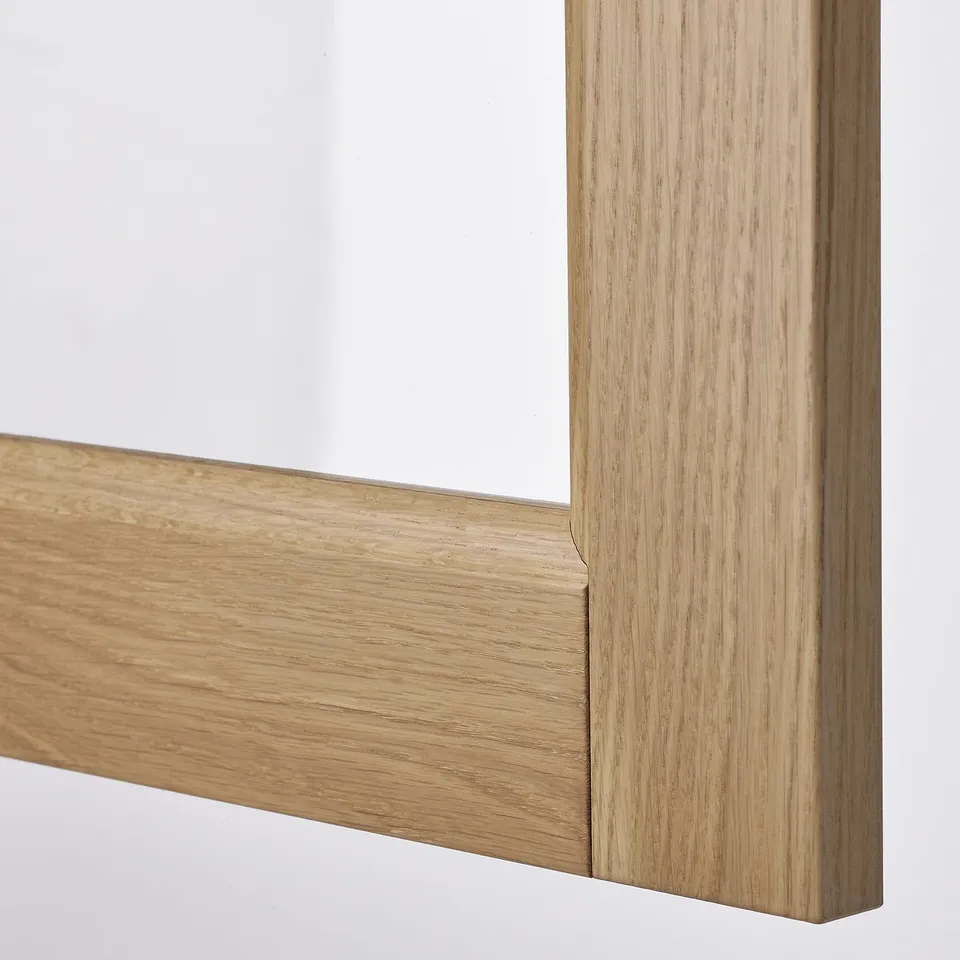 Close-up of high-quality VEDHAMN solid oak kitchen cabinet frame, showcasing natural wood grain and lacquered finish.
