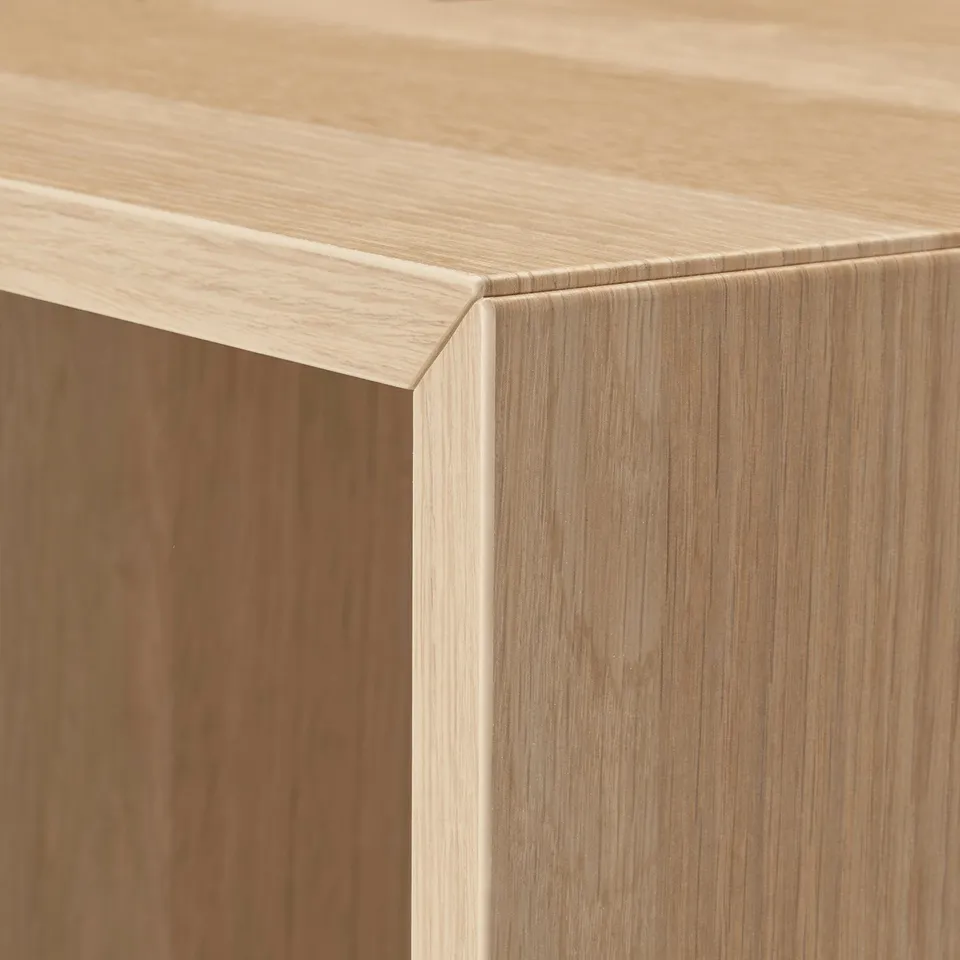 Close-up of smooth, honeycomb-patterned wood panel, showcasing sleek, light wood finish and precise craftsmanship.