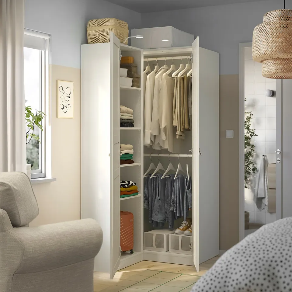 Closed wardrobe with open left section, showing shirts, folded clothes, and storage boxes.