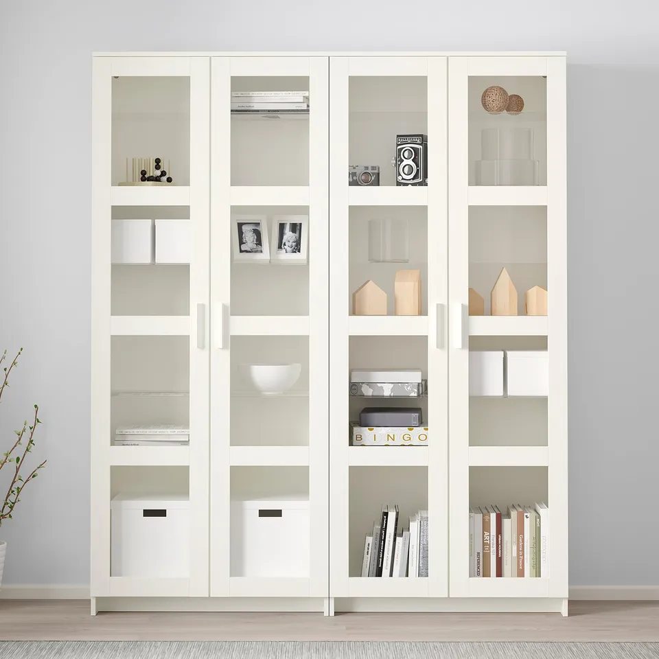 White BRIMNES glass-door display cabinet with decor and books, modern and large.
