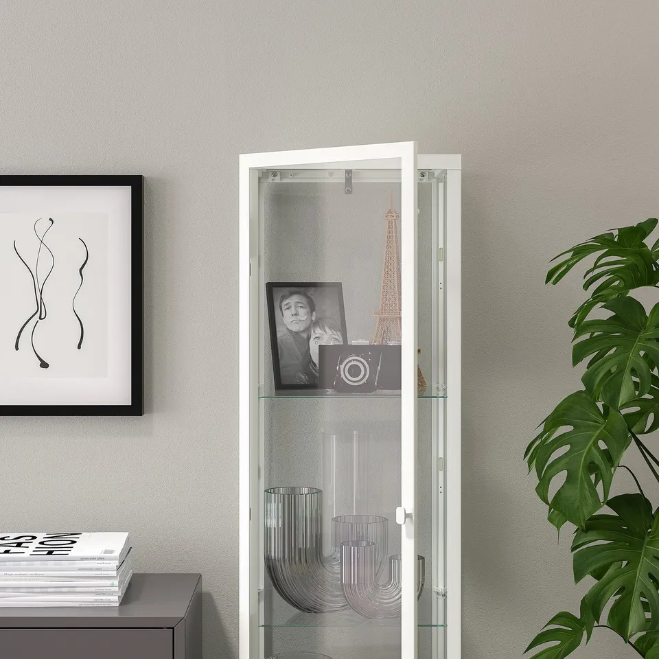 Glass display cabinet with photo, vase, books, and 3 shelves.