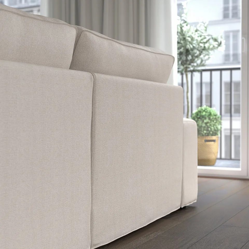KIVIK sofa with chaise, removable arms & springs, light, balcony nearby.