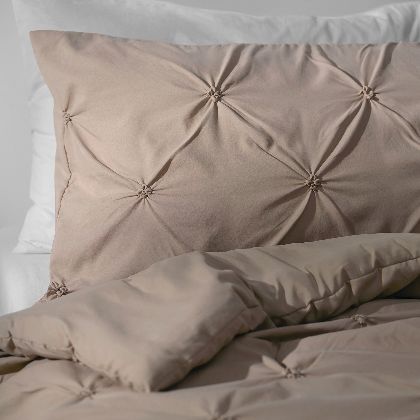 Luxurious bedding set with textured, recycled fabric and plush filling, ensuring comfort and sustainability.