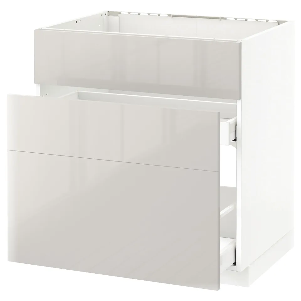 White METOD kitchen cabinet with glossy drawer and slim design.