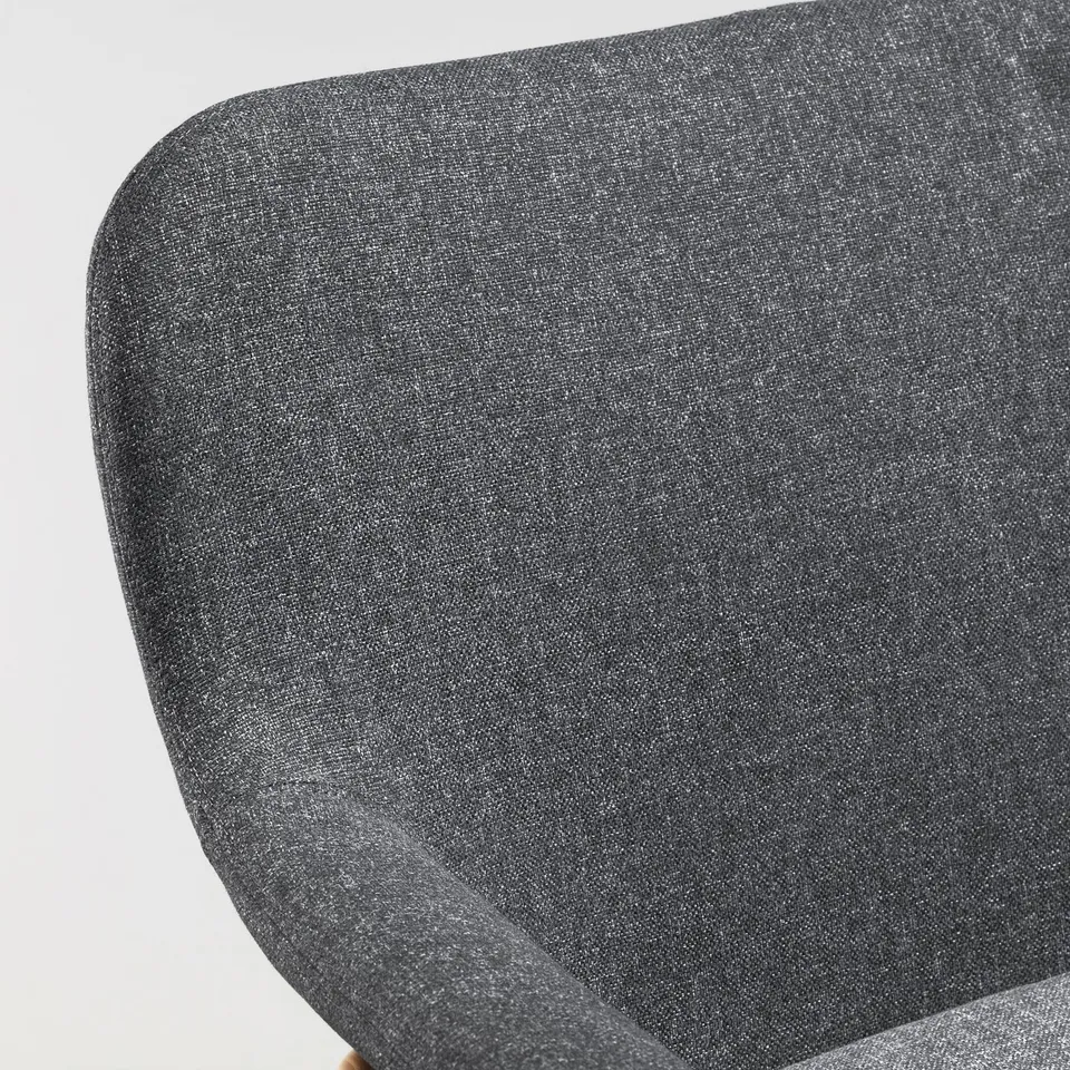 Dark grey upholstered chair, photograph showing seat and backrest, smooth texture, clean design.
