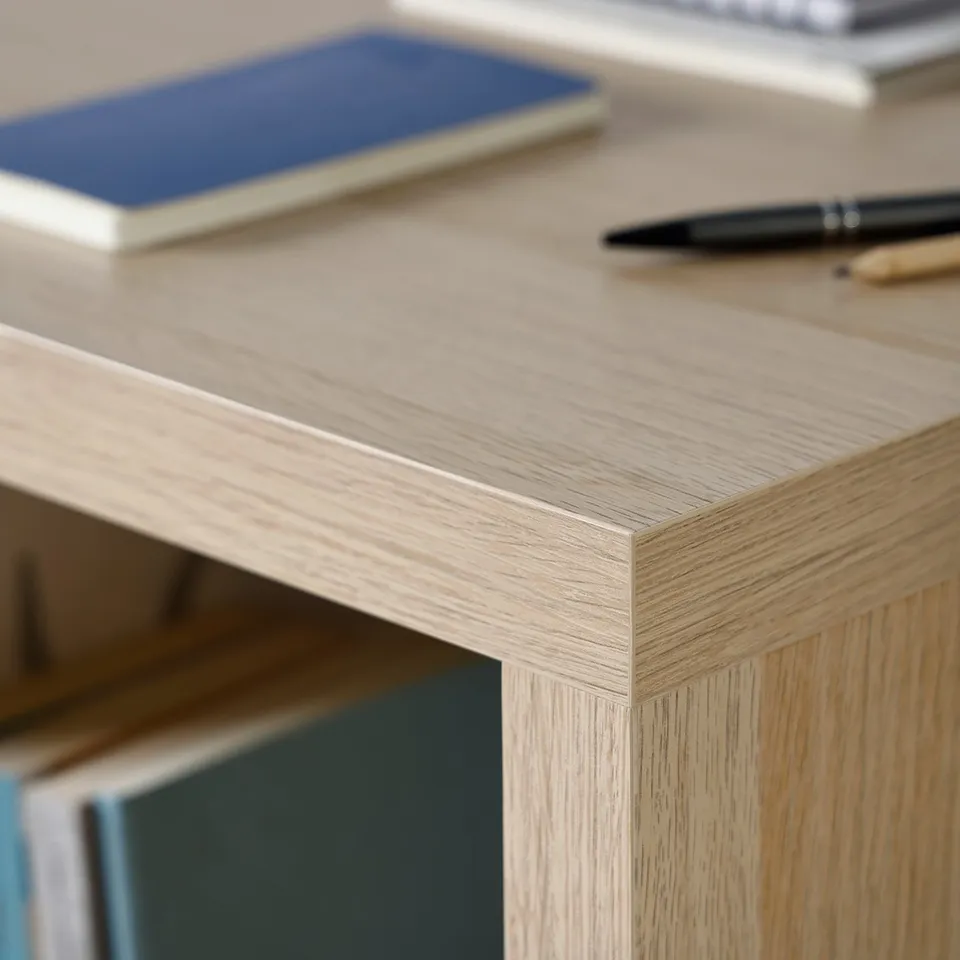 Wooden desk with sleek, smooth surface featuring books, pen, and pencils. Quality craftsmanship evident in visible grain and finish.