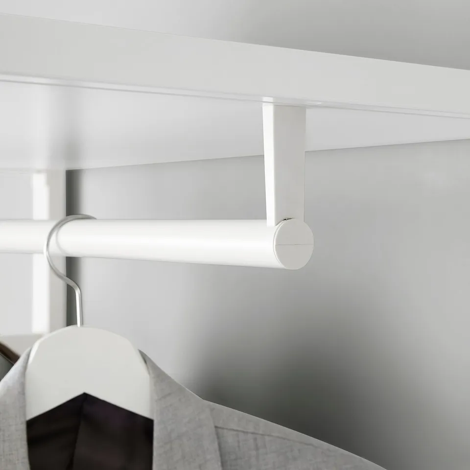 White wardrobe rail extends downward, designed for hanging clothes. Adjusts silently with dampening mechanism for smooth closure.