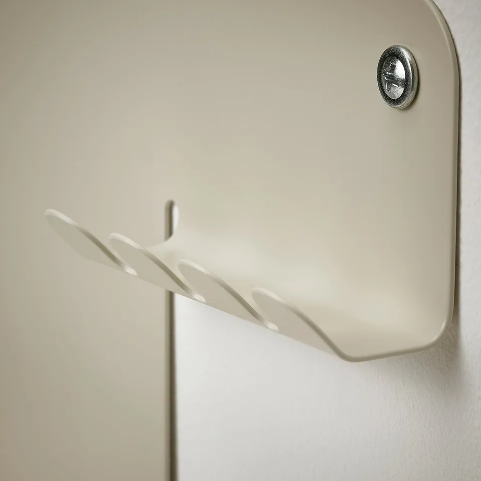 Magnetic wall organiser with a small shelf, attaches securely to wall.