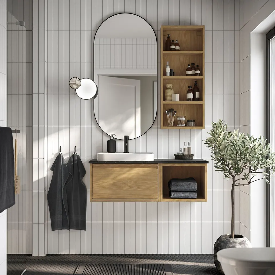 Oak floating vanity with mirror and accessories, modern black accents.