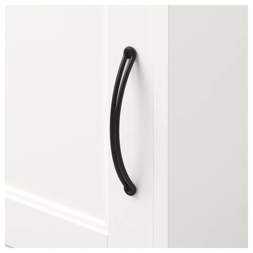Black curved handle on white cabinet door, smooth surface.
