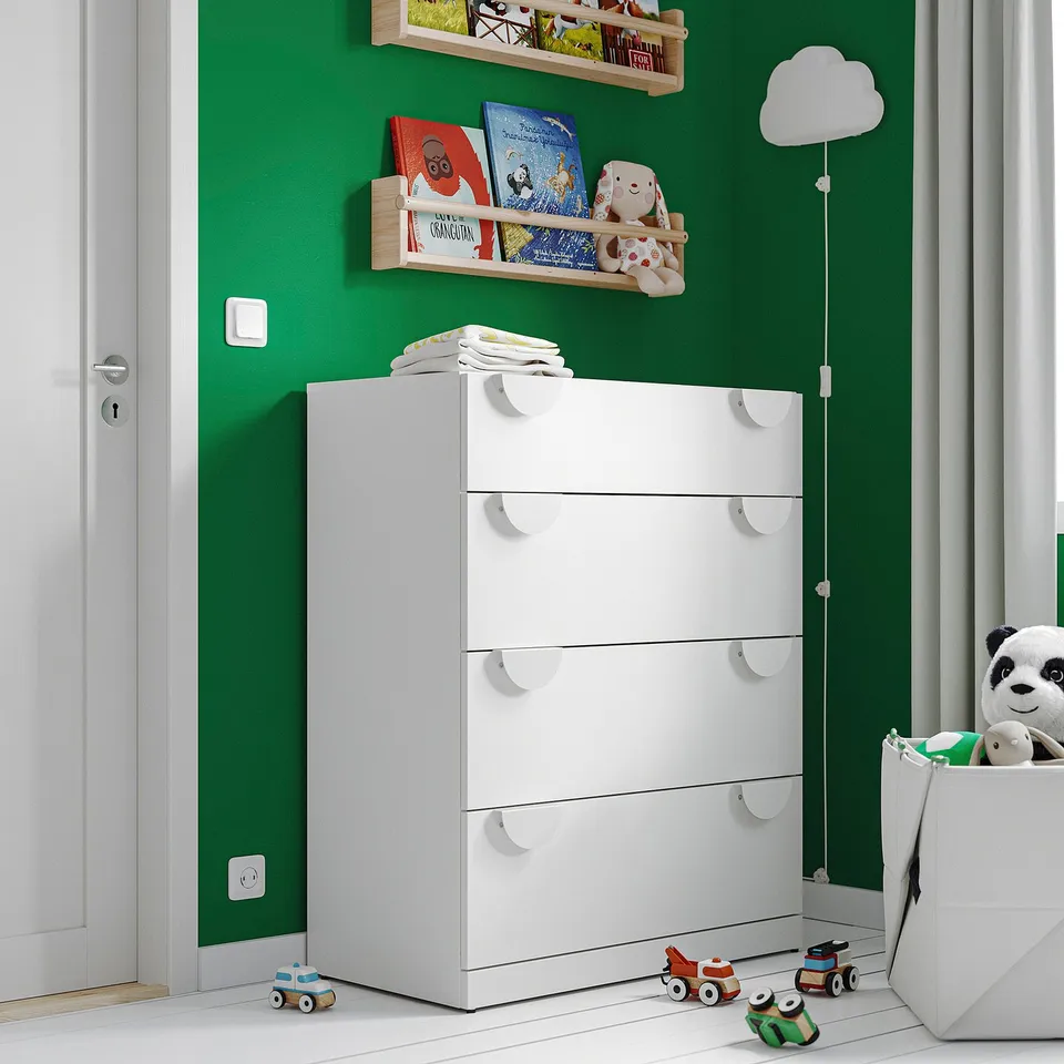 A white LASTARE dresser in a green room with childrens toys.