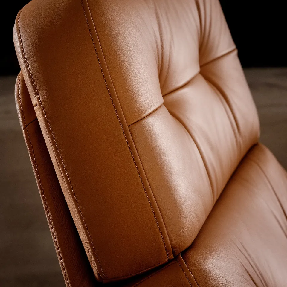 Close-up of top-quality brown leather chair; detailed stitching