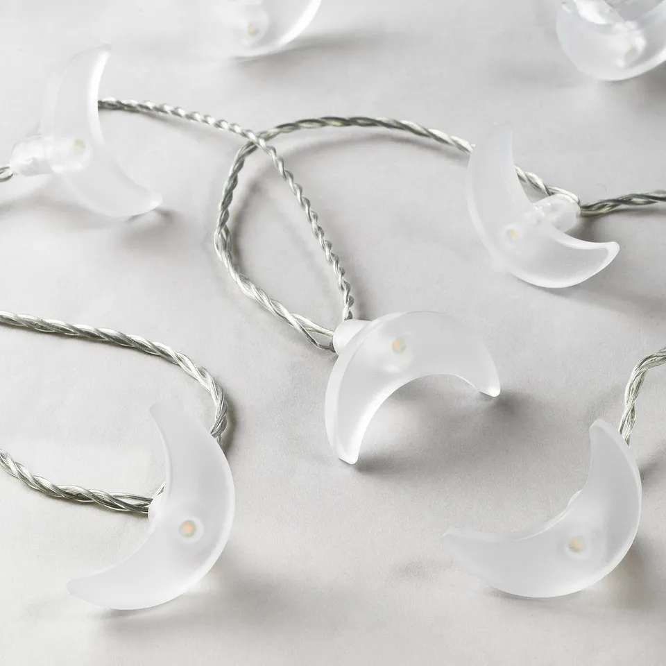 Decorative crescent moon string lights with soft glow, perfect for indoor/outdoor ambiance.