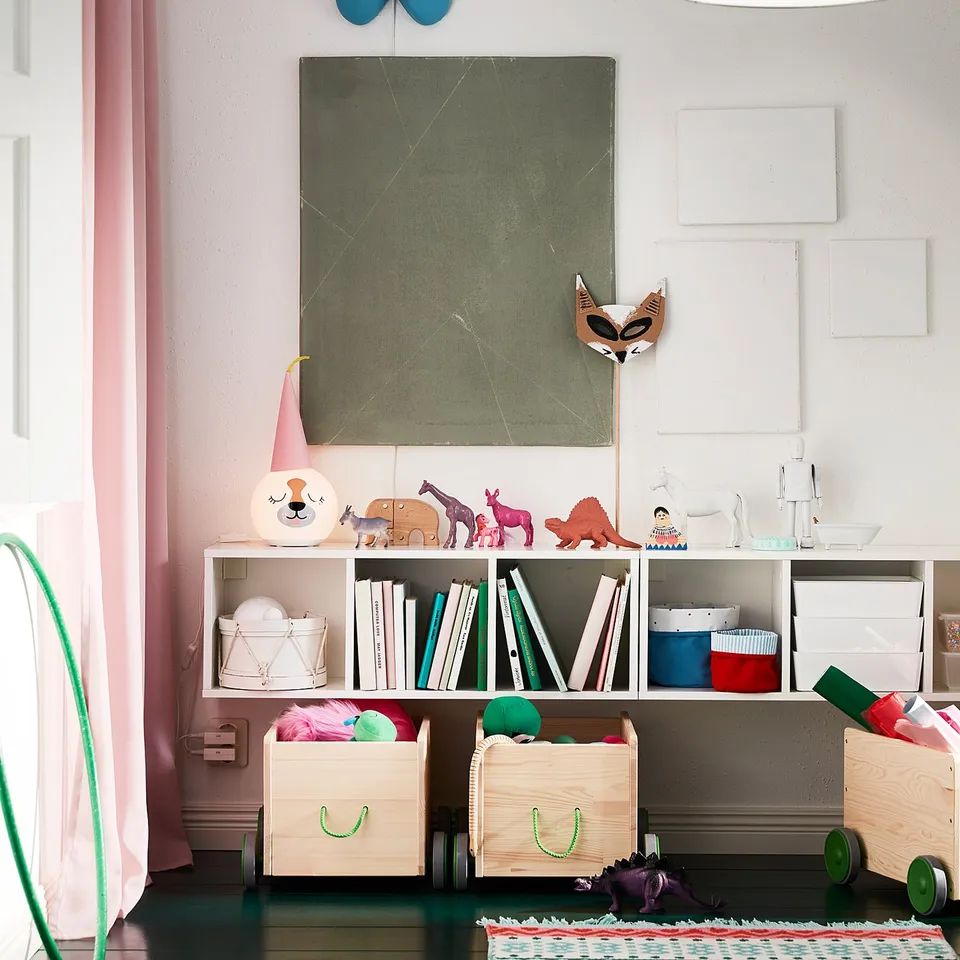 Kids room corner with SMÅGÖRA shelf, blue butterfly decor, books, toys, and green pendant light.