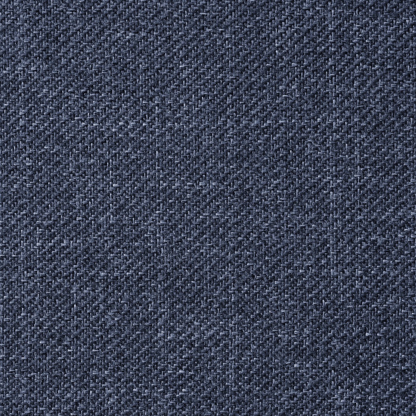 Close-up of a soft, textured grey fabric with a subtle pattern, likely from an upholstered bed frame.