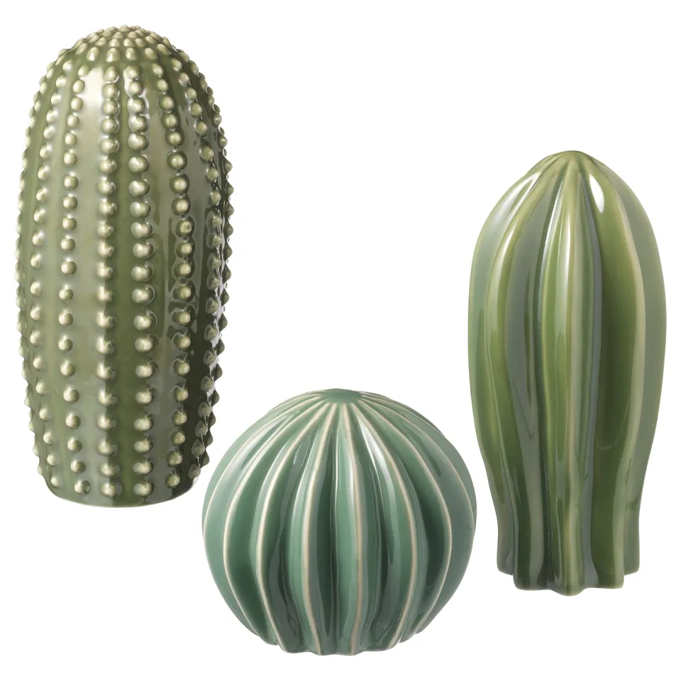 Three green ceramic cacti sculptures: tall cylindrical, round ribbed, thin tall; detailed, modern design.