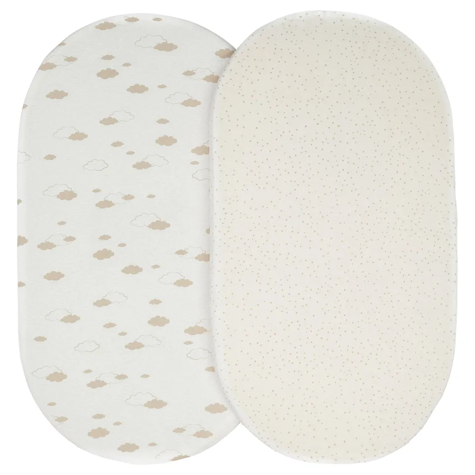Two oval-shaped baby pillows, one white with cloud prints, the other dotted.