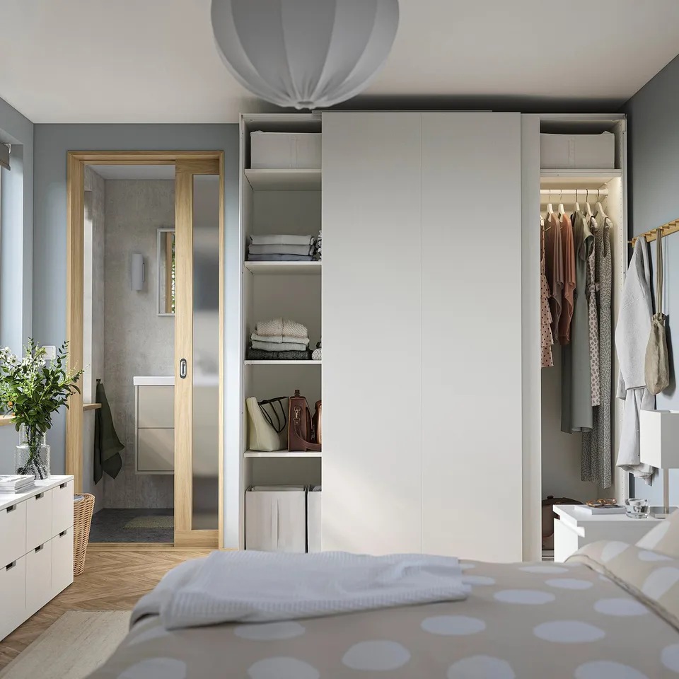 Bedroom with PAX wardrobes: open for clothes, closed with sliding doors, grey walls, wooden floor.